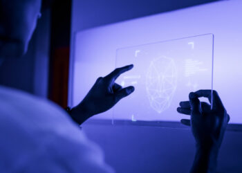Designer using a transparent digital tablet screen futuristic technology